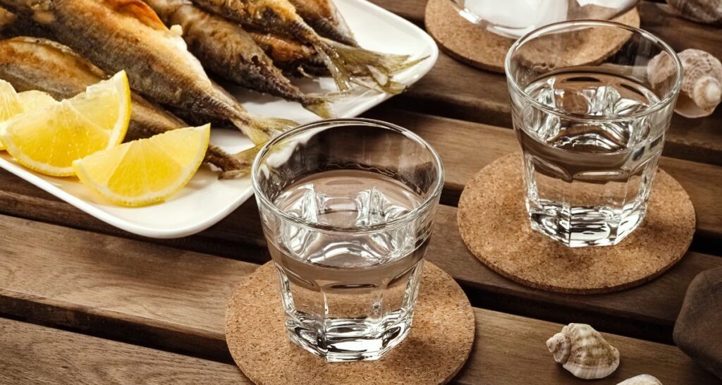 Two shots of tsipouro a greek traditional alcoholic drink served with fish