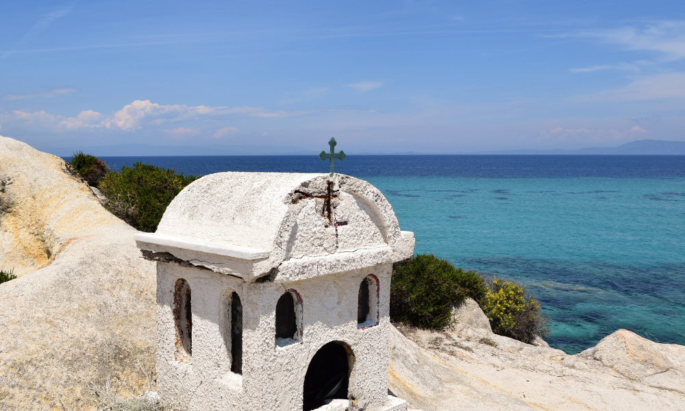 Kavourotripes beach in Sithonia with a small rock church and view of the sea